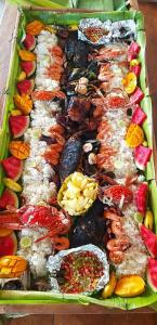 a tray of different types of seafood and vegetables at RICHVILLE LITTLE BORACAY GUEST HOUSE in Calatagan