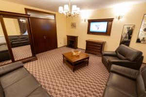 Sala de estar con 2 sofás y TV en Hotel Dorna, en Vatra Dornei