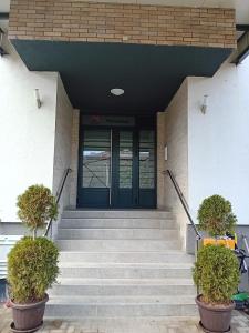 a front door of a building with stairs at Ruma Deluxe 90m2 in Ruma