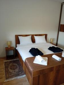 a bedroom with a bed with two towels on it at Ruma Deluxe 90m2 in Ruma