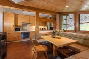 a kitchen with wooden cabinets and a wooden table and chairs at Appartement Berggasse by Schladming-Appartements in Schladming