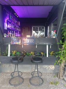 a bar with two bar stools in front of it at Funky Crab The River in Krabi town