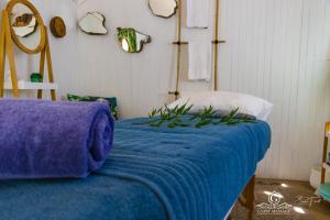 a bedroom with a bed with a blue blanket at Gypsy Guest House Clarens in Clarens