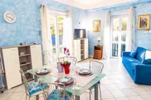 ein Wohnzimmer mit einem Tisch und einem blauen Sofa in der Unterkunft CASA VACANZA FEDERICA in Paratico