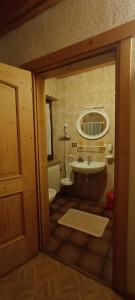 a bathroom with a tub and a sink at Pizzeria Marmolada Camere in Sottoguda