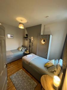 a small room with two beds and a table at Rooms Anfield- 5 mins from LFC in Liverpool