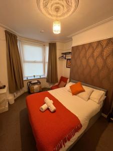 a bedroom with a bed with two towels on it at Rooms Anfield- 5 mins from LFC in Liverpool