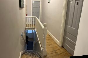 a stairway with a white railing and a stair case at Rooms Anfield- 5 mins from LFC in Liverpool