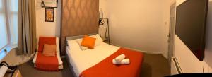 a small bedroom with an orange and white bed at Rooms Anfield- 5 mins from LFC in Liverpool
