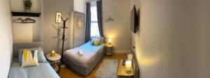 a small room with two beds and a television at Rooms Anfield- 5 mins from LFC in Liverpool