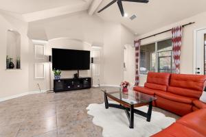 a living room with a red couch and a tv at Randolph Central Location, 1-story, Chef Kitchen, Creekside in Selma