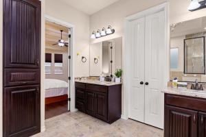 a bathroom with two sinks and a bedroom at Randolph Central Location, 1-story, Chef Kitchen, Creekside in Selma +21 photos
