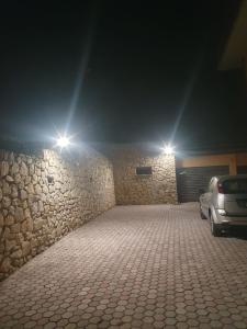 a garage with two lights on a stone wall at B&B paradiso in Paganica