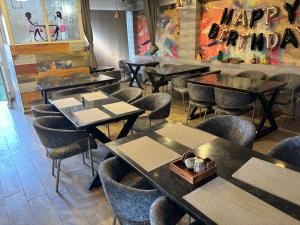 a restaurant with tables and chairs in a room at Hotel Luxurs a unit of knights in Jaipur