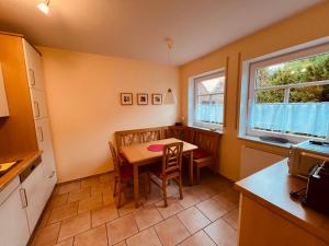 a kitchen with a table and chairs in a room at Ferienhaus Dirka in Norddeich