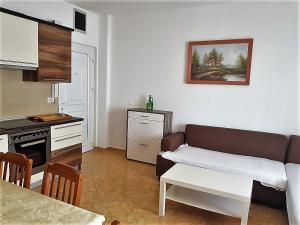 a living room with a couch and a kitchen at Apartment Oasis - Novalja in Novalja