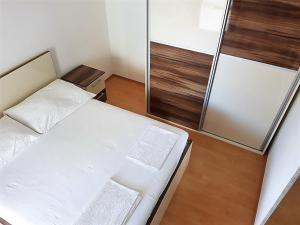 a small room with two beds and a mirror at Apartment Oasis - Novalja in Novalja +22 photos