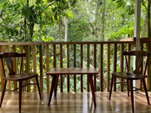 two chairs and a table on a porch at NEW Jungle Casita- Steps away from Punta Uva in Punta Uva