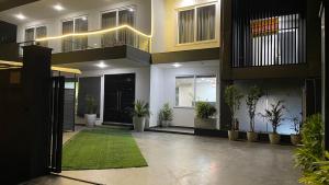 a lobby of a house with potted plants in it at Saltstayz Studio Apartment - Near Artemis & Medanta Hospital in Gurgaon