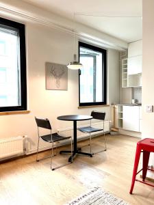 a kitchen and dining room with a table and chairs at Downtown Suite in Helsinki