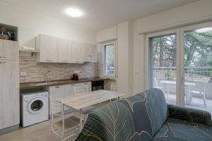 uma cozinha com um sofá e uma mesa numa cozinha em Camelia Studio Apartment with Terrace em Sanremo
