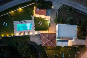 an overhead view of a pool in a yard at night at Villa Paradiso in Blato na Cetini