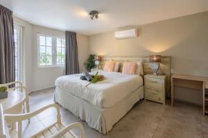 En eller flere senge i et værelse på Appartement Flamboyan op Ocean Resort, Mambo Curaçao