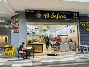 un restaurant avec des gens assis à des tables devant dans l'établissement Couple Suite at Neu Suites near Gleneagles, à Kuala Lumpur