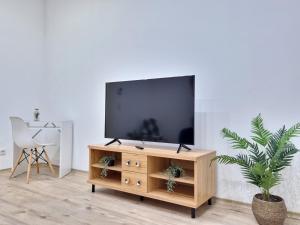 ein Wohnzimmer mit einem Flachbild-TV auf einem Holzschrank in der Unterkunft Like Home in Solingen