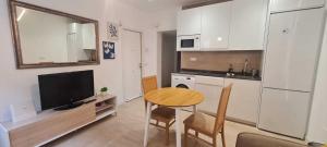 a small kitchen with a table and a television in it at Precioso apartamento recién reformado in Madrid