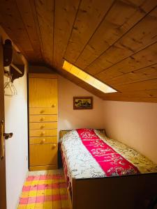 a bedroom with a bed and a wooden ceiling at Hexen Haus in Oberau