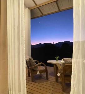 a balcony with a table and chairs and a view at Monko Villa in Pai