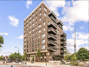 a tall brick building with balconies on a street at Glitz and Luxury in London