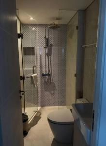 a bathroom with a shower and a toilet and a sink at Cassia Residences in Phuket