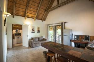 a living room with a table and a couch at Mobola Lodge in Mamono