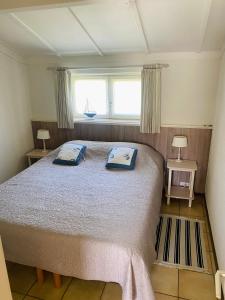 a bedroom with a bed with two pillows on it at Zeepark Zeewind in Bredene