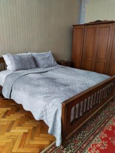 a bedroom with a large bed with a wooden headboard at Villa Garden and Pool near Airport in Norakert +19 photos