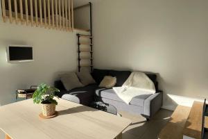 a living room with a couch and a table at Le Clos des Eaux in Tailly