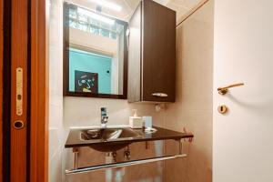 a bathroom with a sink and a mirror at Loft Pozzo Strada in Turin