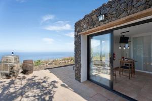 a stone house with a view of the ocean at Apartamento El Moral in Frontera