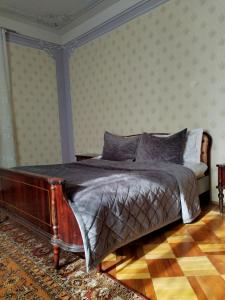 a bedroom with a bed with a wooden frame at GUEST HOUSE SG in Norakert