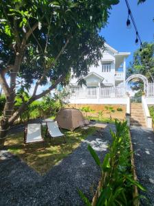 a tent and two chairs in the yard of a house at Nha Trang Riverside Villa in Nha Trang