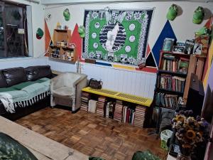 a living room with a couch and a table at Os fora de casa Hostel in Porto Alegre