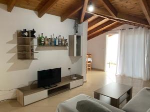 a living room with a flat screen tv on the wall at L.T. Apartment 5th street in Sarandë