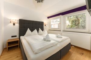 A bed or beds in a room at Villa Waluliso by Schladming-Appartements