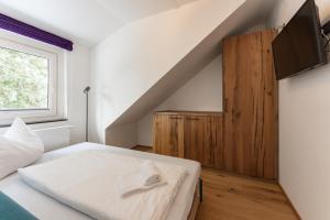 A bed or beds in a room at Villa Waluliso by Schladming-Appartements
