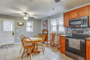 a kitchen with a table and a stove top oven at Lecompton Vacation Rental about 10 Mi to Clinton Lake! in Lecompton
