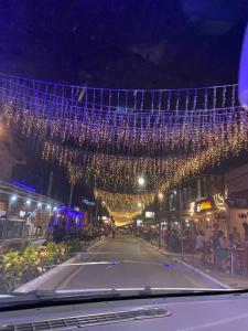 Una calle con luces de Navidad colgando sobre una carretera en Suítes a 15 metros da praia en Marechal Deodoro