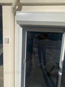 a person is standing in a room with a window at Appartement a Cornebarrieu in Cornebarrieu