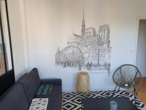 a living room with a drawing on the wall at Suite Forum Vue Imprenable in Reims